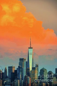 an orange and pink sky is over the cityscape in new york's financial district