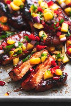 grilled pork with pineapple salsa on a baking sheet, ready to be eaten