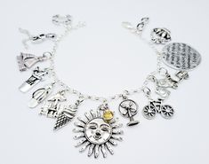 "For the love of Summer ☀️ This charm bracelet is a special find for all the summertime lovers out there. It features a collection of (15 antique silver charms) on a 3.5 mm sterling silver. 925 rolo bracelet chain. The charms on the bracelet represents some of the excitements of the season of summer.  The charms on this bracelet are: the sun, flip flop, crab, picnic basket, bicycle, umbrella chairs, sunglasses, cocktail drink, ice cream cone, fan, sail boat, shorts, moped, girl running, and a di Friendship Themed Charm Bracelet, Spiritual Sterling Silver Charm Bracelet For Friendship, Symbolic Vintage Charm Bracelet For Gift, Silver Themed Bracelets For Friendship, Handmade Silver Charms For Friendship, Handmade Silver Charm Bracelet For Friendship, Symbolic Silver Charm Bracelet For Friendship, Silver Charm Bracelet With Lobster Clasp For Friendship, Moped Girl