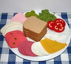 a white plate topped with lots of different types of food on top of a blue and white checkered table cloth