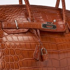 Extraordinary, exclusive creations, meticulously handcrafted by an Austrian-born master craftsman in South Africa. Made from genuine crocodile skin sourced through Hermes Cuir Précieux, the epitome of elegance and prestige Original Retail Price: $12,000 Large Hermes Birkin 35-style bag. Pre-owned Cognac Color Genuine Nile Crocodile Skin ( Hermes cuir precieux) Tote with side straps and turn-lock hanging key fob croc skin-wrapped padlock with a set of keys two rounded top handles internal zip poc Nile Crocodile, Hermes Birkin 35, Cognac Color, Crocodile Skin, Crocodile Leather, Hermes Birkin, Key Fob, Cognac, South Africa