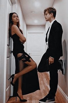 a man and woman standing next to each other in front of a door with the caption siz u