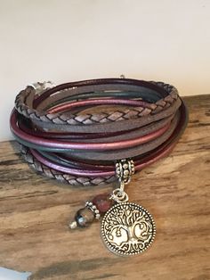 This bracelet is Perfect if you like the boho style with natural leather with that cool Boho Style! Beautiful shades of Gray, burgundy and berry made with genuine bolo braided cord, soft suede cord and 2mm round leather cord. This wrap is made to wrap around your wrist twice and enclosed with a lobster clasp. It has a small extension chain on the end to adjust to a snug or loose fit. Your bracelet comes with the little 6mm drop beads shown and your choice of silver charm. Take a look at the last Adjustable Pink Bohemian Wrap Bracelet, Bohemian Adjustable Pink Wrap Bracelet, Adjustable Bohemian Pink Wrap Bracelet, Bohemian Pink Wrap Bracelet For Festival, Bohemian Leather Bracelet, Pink Bohemian Wrap Bracelet, Hippie Brown Wrap Bracelet For Festivals, Brown Hippie Wrap Bracelet For Festivals, Handmade Bohemian Pink Wrap Bracelet