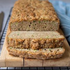 a loaf of meatloaf sitting on top of a cutting board next to a knife