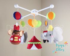 two stuffed animals hanging from a mobile in a child's playroom or nursery