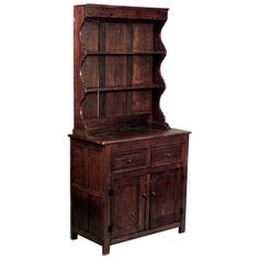 an old wooden cabinet with drawers and cupboards on the front, against a white background