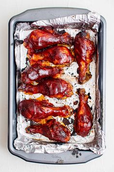 raw chicken wings in tin foil on a baking sheet ready to be baked into the oven