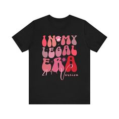 a black t - shirt with pink and red lettering