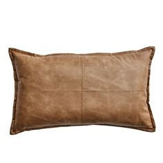 a brown leather pillow on a white background