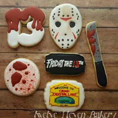 cookies decorated to look like the friday the 13th movie characters are on a wooden table