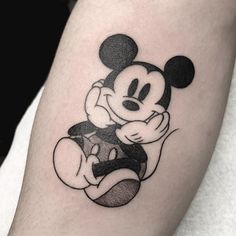 a small mickey mouse tattoo on the right arm and leg, it is black and white