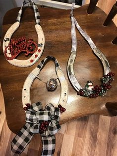 three pieces of jewelry sitting on top of a wooden table