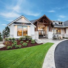 a large house that is sitting on the side of a road with grass in front of it