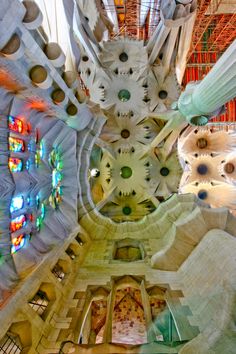 the interior of a large building with many colorful lights on it's ceiling and stained glass windows