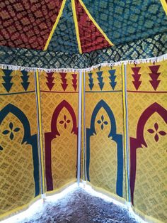 the inside of a tent with several different colors and patterns