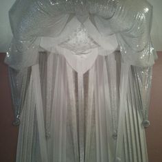 a white curtain with sequins hanging from it's sides