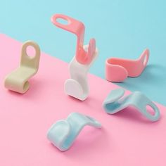 three different types of baby toys on a pink and blue background