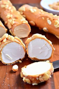 some kind of food that is cut in half on a cutting board with a knife