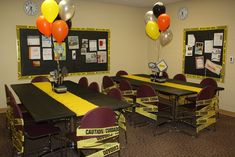 an empty classroom with tables and chairs decorated for school year celebrations, balloons are floating in the air