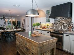 a kitchen with an island in the middle and a clock on the wall behind it