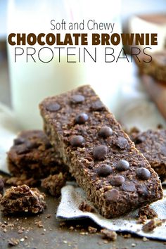 chocolate brownie protein bars are stacked on top of each other and next to a glass of milk