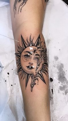 a person with a sun tattoo on their arm