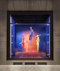 a window display with mannequins dressed in bright colors