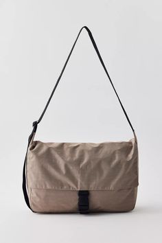 A functional, go-to bag with two large exterior pockets in addition to the main interior compartment. Has an interior laptop sleeve with velcro closure that fits 13/14” laptop in a puffy case. Bag Dimensions: 10 in. H x 14.5 in. W x 4.5 in. D Exterior Front Slip Pockets (x2) : 7.5 in H x 8 in. W Interior Back Computer Pocket: 14.5 in. W (Fits a 13/14" computer in our Puffy Sleeve) Adjustable Strap: 45 in Machine wash cold Body: 100% Nylon (59% Recycled) / Lining: 100% Nylon (40% Recycled) Outdoor Nylon Bag With Laptop Sleeve, Nylon Bags With Laptop Sleeve For Commuting, Nylon Commuter Bag With Laptop Sleeve, Nylon Laptop Sleeve Rectangular Bag, Rectangular Nylon Bag With Laptop Sleeve, Everyday Nylon Bag With Laptop Sleeve, Nylon Rectangular Bag With Laptop Sleeve, Nylon Shoulder Bag With Laptop Sleeve For Daily Use, Functional Nylon Shoulder Bag With Laptop Sleeve