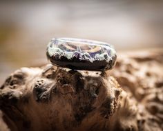 a glass ring sitting on top of a rock