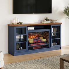 an entertainment center with a fire place and television on it's stand, in front of a wall mounted flat screen tv