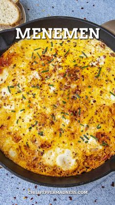 a close up of a pizza in a pan with the words menemen on it