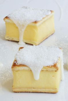 three pieces of dessert sitting on top of a white table