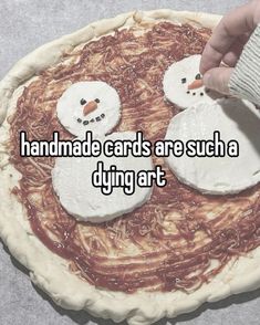 someone is decorating a cake with two snowmen on it and the words handmade cards are such a dying art