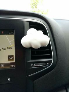 an air vent in the dashboard of a car with a cloud shaped object on it