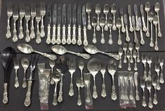 an assortment of silverware is displayed on a table