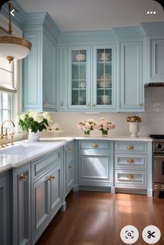 a kitchen with blue cabinets and white counter tops