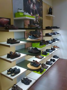 there are many pairs of shoes on the shelves