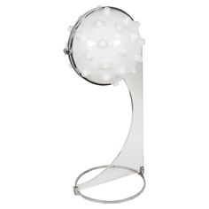 a glass table lamp with white balls on it