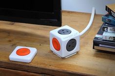 an orange and white cube sitting on top of a wooden table