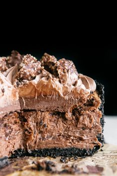 a piece of chocolate cake on top of a wooden cutting board