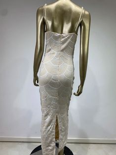 a mannequin wearing a white dress on display