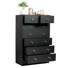 a black dresser with five drawers next to a potted plant on top of it