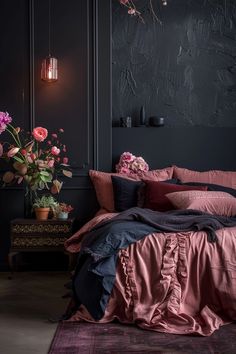 a bedroom with black walls and pink bedding in the corner, along with flowers