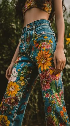 Colorful hand-painted jeans adorned with floral patterns, showcased on a model in natural light, shot using a Canon EOS R5 and RF 50mm f/1.2L lens with rich details. Floral Pant Outfit, Painted Mom Jeans, Painted Jeans Mushroom, Sunflower Painted Jeans, Floral Painted Jeans, Fabric Painted Jeans, Diy Painted Jeans Ideas, Denim Jeans Painting Ideas, Jeans Painting Ideas Aesthetic