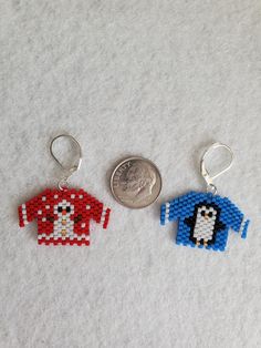 two keychains made to look like pixelated items, one with a penguin on it and the other with a t - shirt