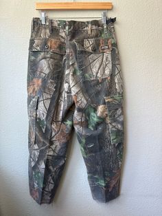 Vintage Wragler Camo Cargo Pants Nice Real Tree Camo Super Soft Zipper and Button closure  Large cargo pockets 50% cotton 50% polyester  Waist 15" Rise 12" Inseam 25" Length 36" *FOLLOW US ON INSTAGRAM!* @ventana_thirteen_vintage Thank you for visiting :) **PLEASE NOTE** vintage items are pre-owned and not new.  ~all items are final sale if you're in doubt, please ask for measurements or information. although i try to reflect colors accurately, there may be slight differences in their appearance Outdoor Fall Bottoms With Patch Pockets, Cotton Camouflage Bottoms With Belt Loops, Casual Cotton Hunting Pants, Camouflage Straight Leg Bottoms With Patch Pockets, Camouflage Straight Leg Outdoor Bottoms, Camouflage Straight Leg Bottoms For Outdoor, Camouflage Cotton Bottoms With Hip Pockets, Straight Leg Camouflage Bottoms For Outdoor, Utility Hunting Bottoms With Pockets