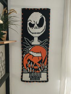 a wall hanging with an image of jack skellingy and pumpkins on it