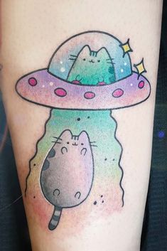 a tattoo with a cat and an alien ship on it's thigh, in the shape of a spaceship