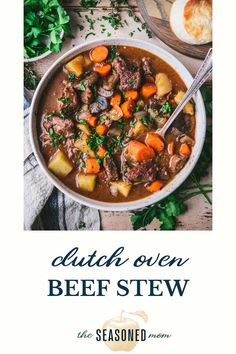 a bowl of beef stew with carrots, potatoes and parsley on the side