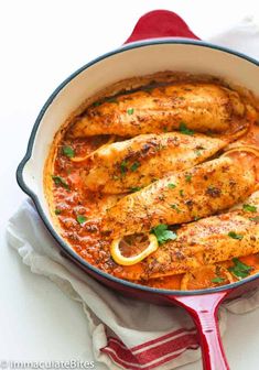 a pan filled with chicken and tomato sauce